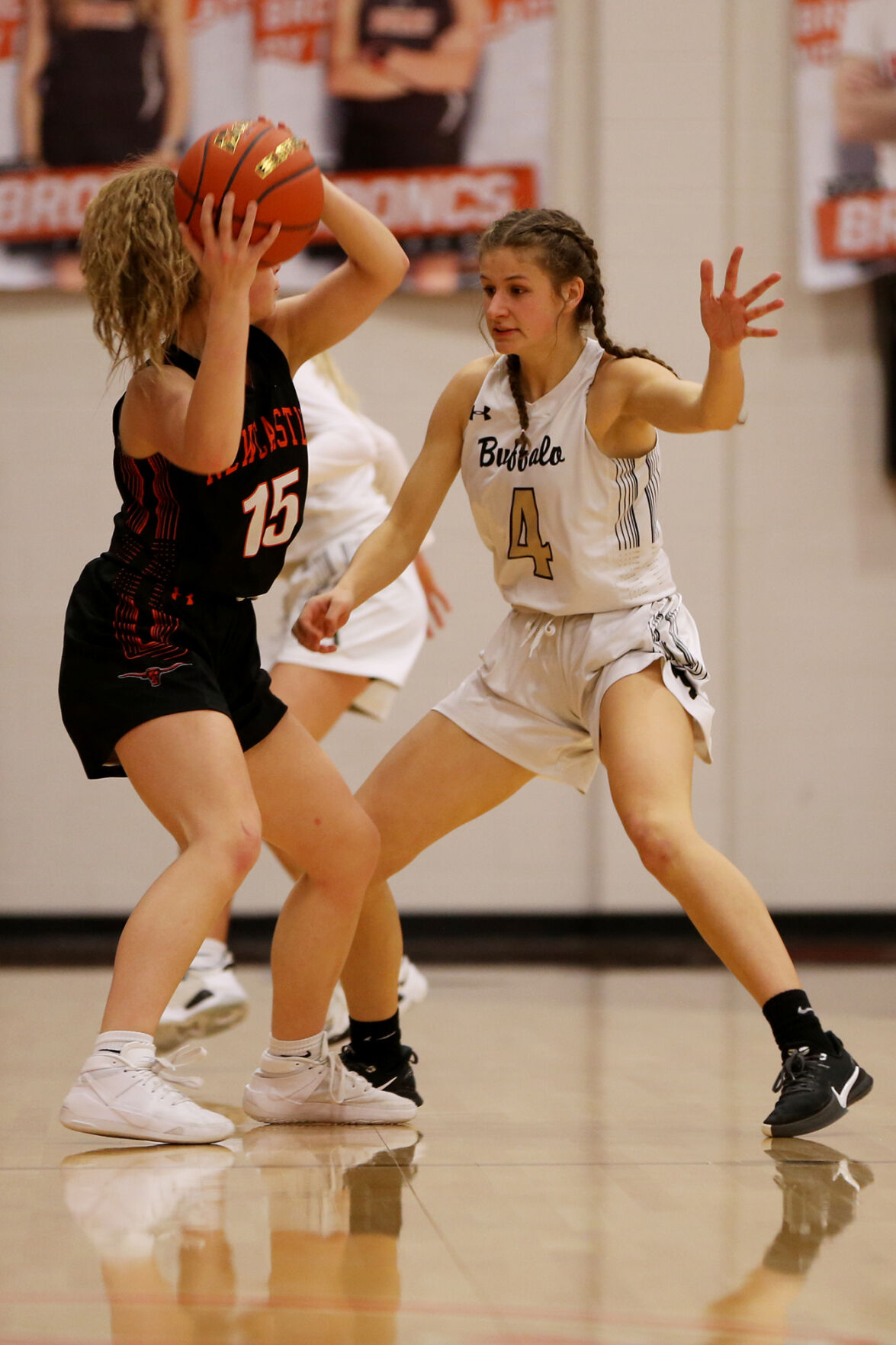 Lexi Rule waves her hands as she defends against Newcastle junior Hunter McFarland